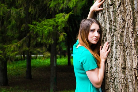 Pin-up model and big tree. Shoot in summer.の写真素材