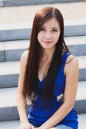 Sexy girl sitting on the stairs in the Park.の写真素材