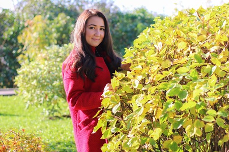 beautiful asian woman in red coat. Outdoorの写真素材