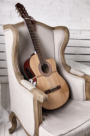 Acoustic guitar on an old armchair