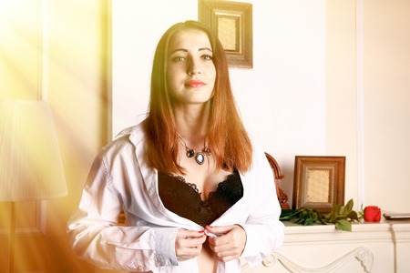 Sexy woman unbuttoned blouse revealing her braの写真素材