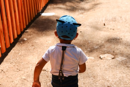 Little boy in a funny Cap somewhere goesの写真素材