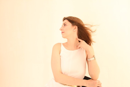 Portrait of caucasian girl with brown hair posing isolated on white backgroundの写真素材