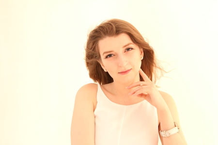 Portrait of caucasian girl with brown hair posing isolated on white backgroundの写真素材