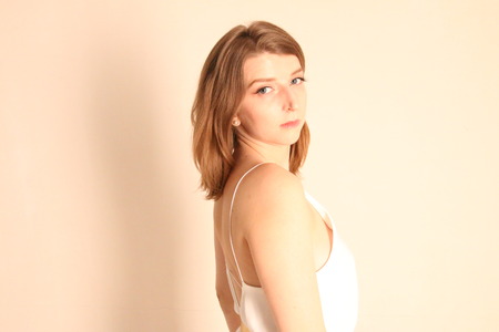 Portrait of caucasian girl with brown hair posing isolated on white backgroundの写真素材