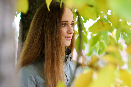 young woman portrait in autumn colorの写真素材