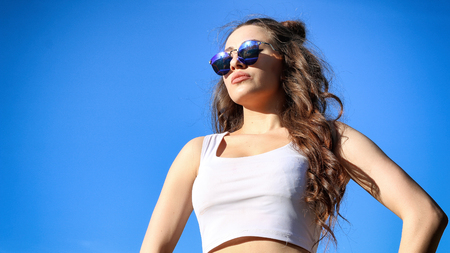 Beautiful Young Woman over blue Skyの写真素材