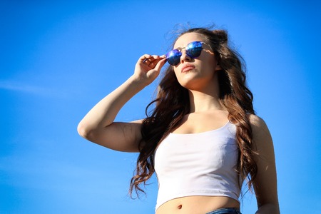 Beautiful Young Woman over blue Skyの写真素材