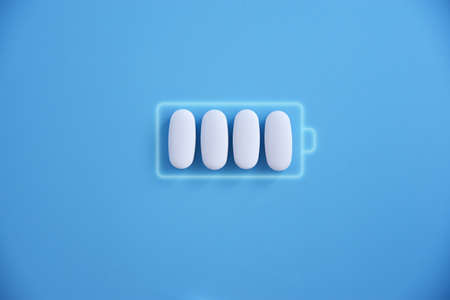 Battery and white pill medicine, energy for life, idea Battery charging symbol and capsules. Health...