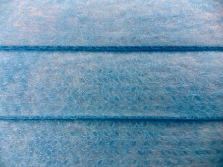 Folded blue surgical mask macro shot