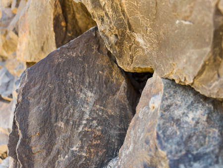 Wall of large rough uneven granite stones. High quality close-up photo