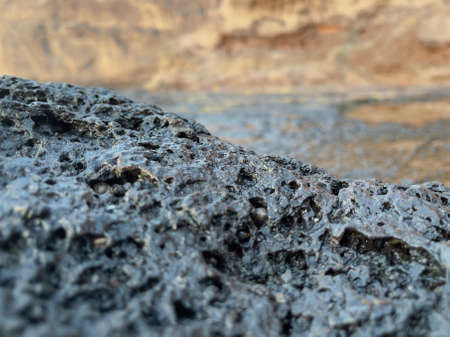 Porous volcanic rock on blurred mountain background. High quality photoの写真素材