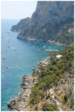 beautiful view of the rocks of the island of Capri and yachtsの写真素材