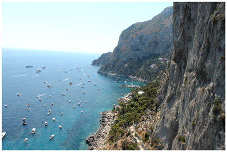 beautiful view of the rocks of the island of Capri and yachtsの写真素材