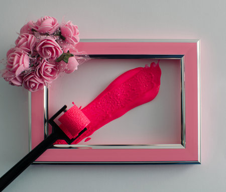 I decorate the bright frame with flowers and feathers of pastel pink color that goes well with the white background. The harmony of colors awakens motives of tenderness and love. Flat lay.の写真素材