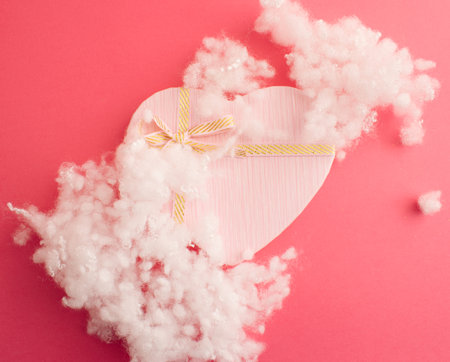 Valentine's present. Beautiful box in pink pastel color in harmony with background. Flat layの写真素材