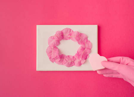Pink circle made of flowers petal on pink background. Flat lay conceptの写真素材