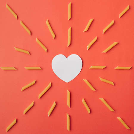 Sunny pasta love on red background. Flat layの写真素材