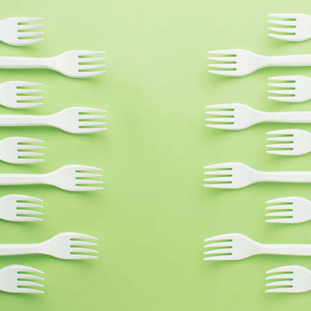 Pattern of white forks on green background. Healthy and organic concept. Flat layの写真素材