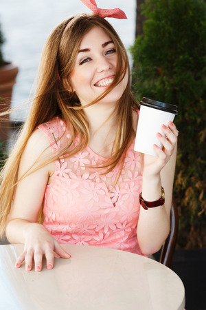 girl sitting at the table and laughingの写真素材