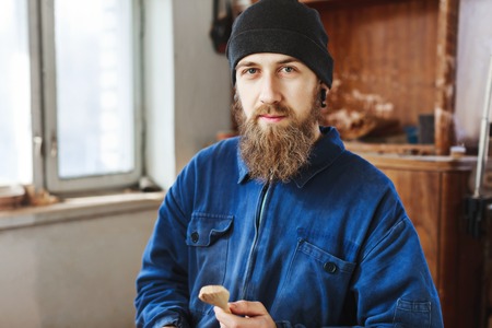 A man working with woodcarving instrumentsの写真素材