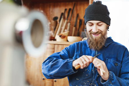 A man working with woodcarving instrumentsの写真素材