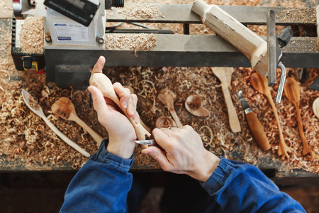 A man working with woodcarving instruments