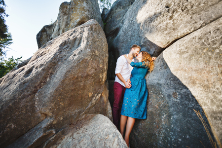 Cute couple embracing near rocksの写真素材