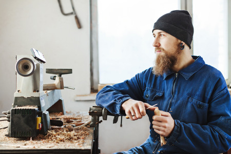A man working with woodcarving instruments