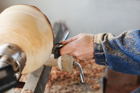 A man working with woodcarving instrumentsの素材 [FY310122482939]