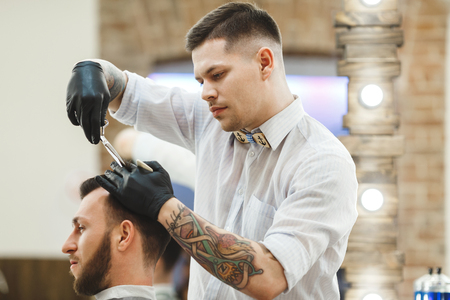 Barber doing haircuts for clientの写真素材