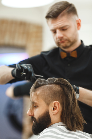 Barber doing haircuts for clientの写真素材