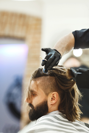 Barber doing haircuts for clientの写真素材