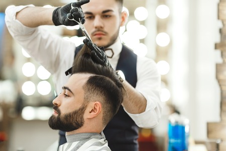 Barber doing haircuts for clientの写真素材