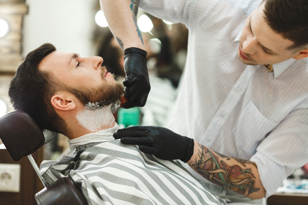 Barber making beard form for manの写真素材