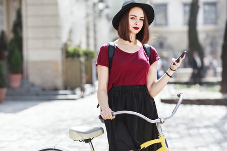 Girl on bicycle with phoneの写真素材