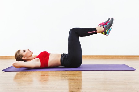 Fit girl doing physical exercisesの写真素材