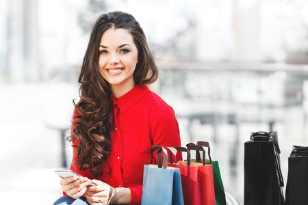 Smiling girl sitting in mallの写真素材