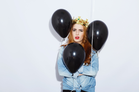 Stylish girl with balloons on white backgroundの写真素材
