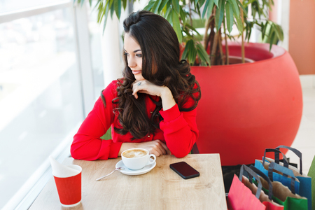 Cute girl in cafe at shopping mallの写真素材