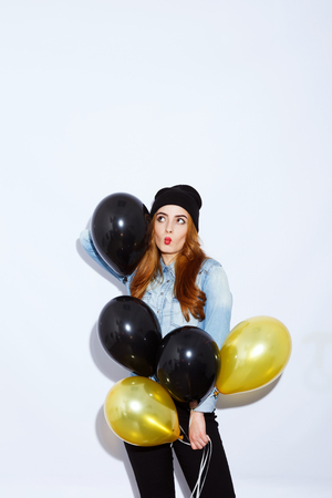 Stylish girl with balloons on white backgroundの写真素材