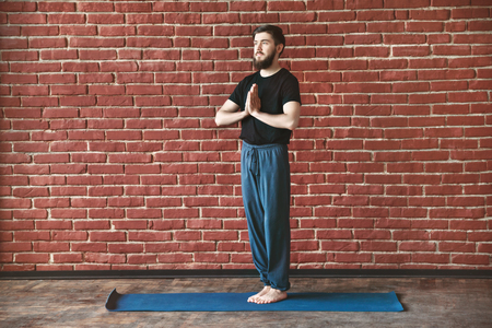 Handsome man doing yoga positionsの写真素材
