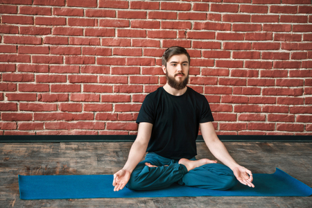 Attractive man doing yogaの写真素材