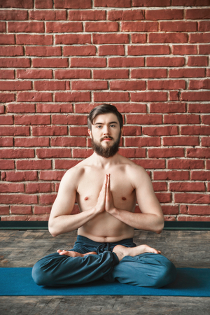 Handsome man doing yoga positionsの写真素材