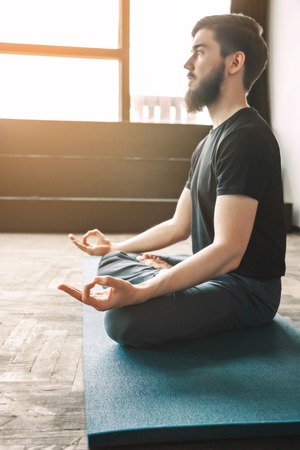 Attractive man doing yogaの写真素材