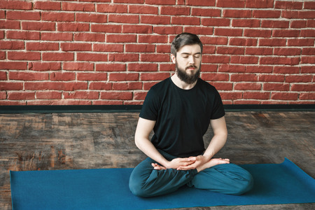 Attractive man doing yogaの写真素材