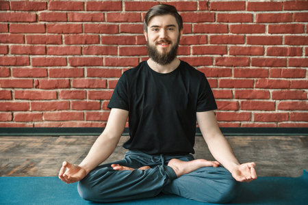 Handsome man doing yoga positionsの写真素材