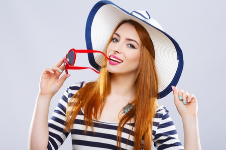 Girl with hat, striped T-shirt and sunglassesの写真素材