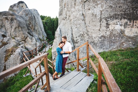 Couple on wooden bridge between rocksの写真素材