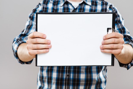 Tablet with white sheet of paperの写真素材